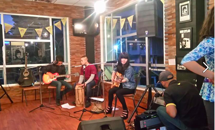 Live music performance at a local Shillong cafe with youth embracing thrift fashion and creative style.