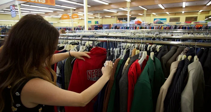 A student browsing an eco-friendly thrift store in Shillong.